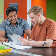 Dyspraxia | Supporting learner Success PLD image of two male learners looking at a iPad